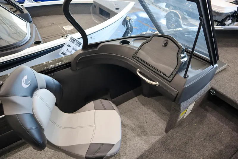Slide: The Image of 2025 Crestliner 1850 Super Hawk WT JS boat interior with gray seating and dashboard. - 7