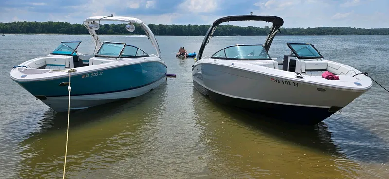 Slide: The Image of Two 2023 Regal LS6 boats anchored on a calm lake. - 4