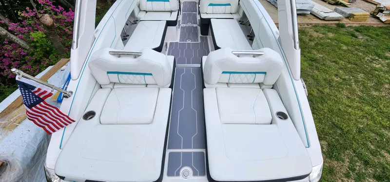 Slide: The Image of 2023 Regal LS6 boat interior with white seating and American flag. - 9