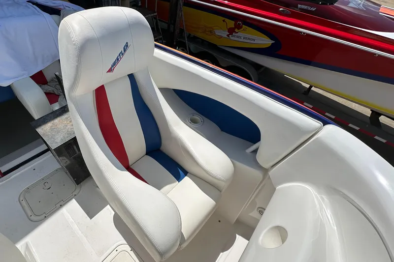 Slide: The Image of 2003 Hustler 377 Talon boat seat with red, white, and blue design. - 10