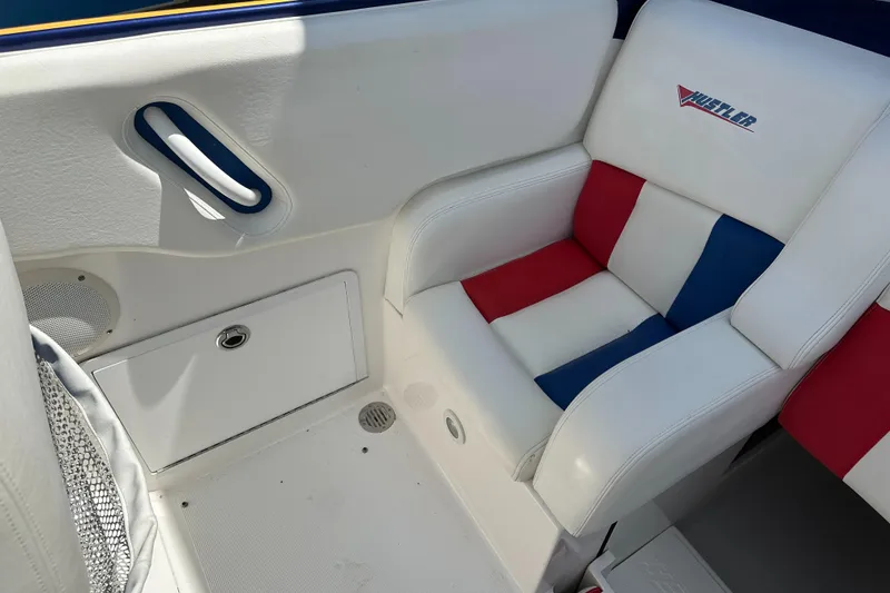 Slide: The Image of 2003 Hustler 377 Talon boat interior with red, white, and blue seating. - 12