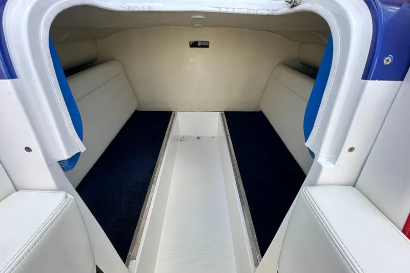 Slide: The Image of Interior of 2003 Hustler 377 Talon boat, featuring spacious seating and sleek design. - 14