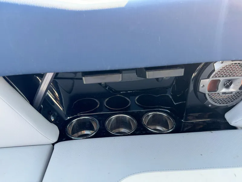 Slide: The Image of 2022 MasterCraft NXT20 boat interior with cup holders and speaker. - 15