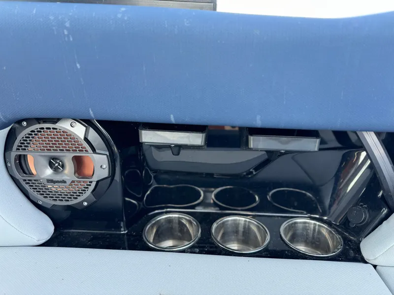 Slide: The Image of 2022 MasterCraft NXT20 boat interior with speaker and cup holders. - 16