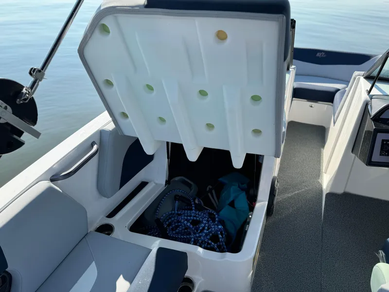 Slide: The Image of 2022 MasterCraft NXT20 boat interior with open storage compartment. - 18