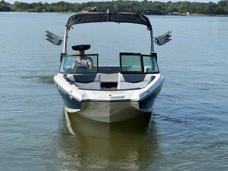 Slide: The Image of 2022 MasterCraft NXT20 boat cruising on a calm lake. - 2