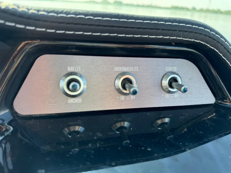 Slide: The Image of Control panel of 2022 MasterCraft NXT20 boat with switches for lights and anchor. - 24