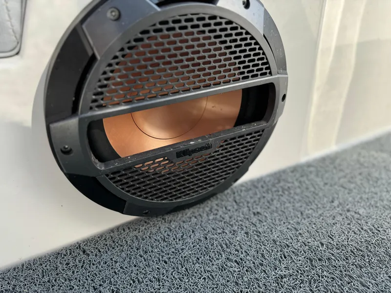 Slide: The Image of Close-up of a 2022 MasterCraft NXT20 boat speaker with a protective grille. - 31