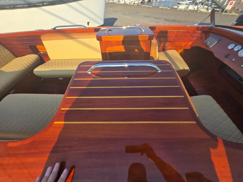 Slide: The Image of Interior of a 2018 Cherubini Classic 24 boat with polished wood and beige seating. - 14