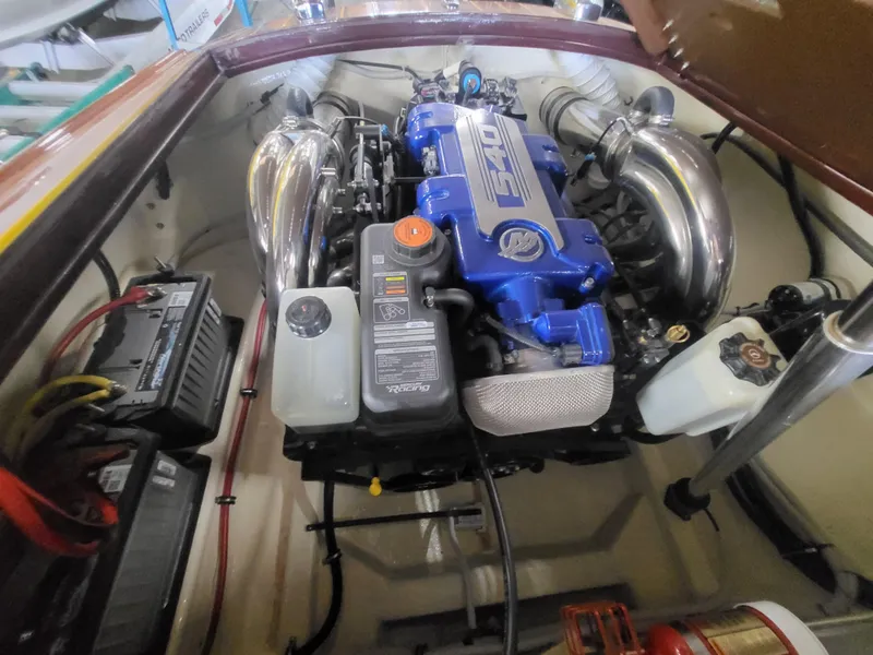 Slide: The Image of Engine compartment of a 2018 Cherubini Classic 24 boat, featuring a powerful blue engine. - 2