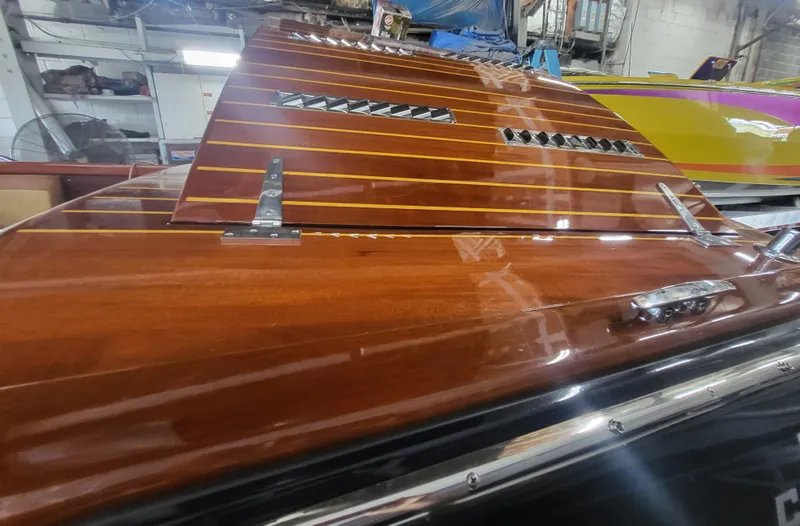 Slide: The Image of Engine of 2018 Cherubini Classic 24 with blue cover and chrome exhausts. - 23