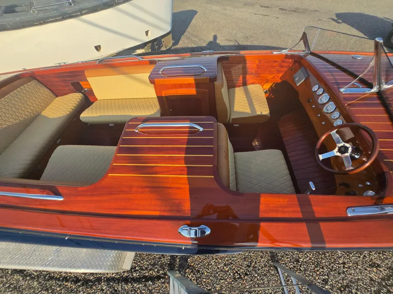 Slide: The Image of 2018 Cherubini Classic 24 boat interior with polished wood and beige seating. - 3