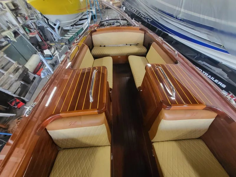 Slide: The Image of Engine compartment of a 2018 Cherubini Classic 24 boat, featuring a blue engine. - 31