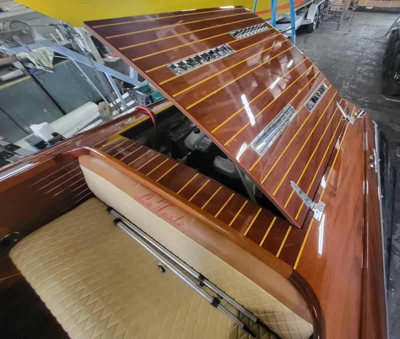 Slide: The Image of 2018 Cherubini Classic 24 interior with wooden finish and beige cushioned seating. - 34