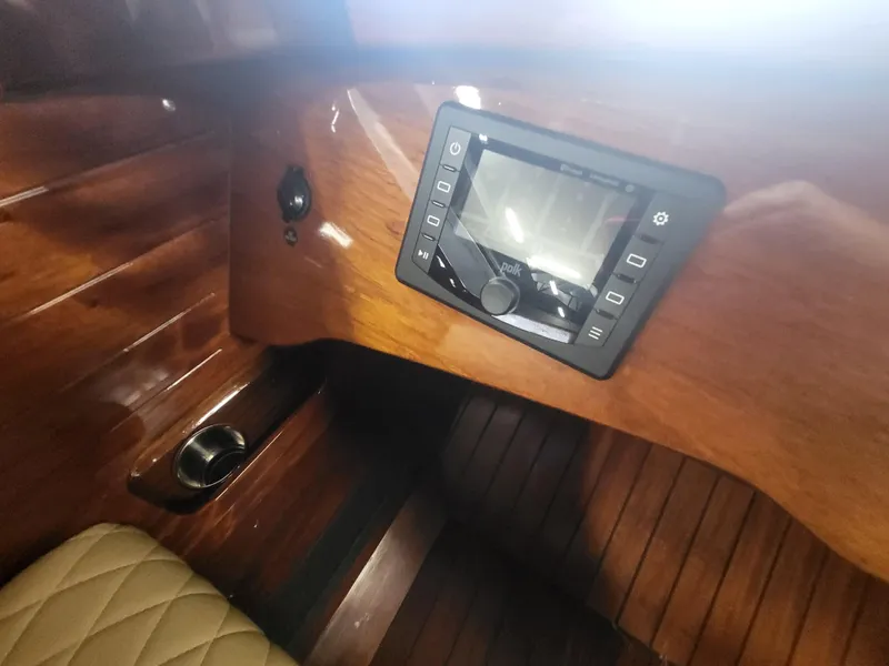 Slide: The Image of Interior of 2018 Cherubini Classic 24 boat with wooden finish and beige seating. - 38