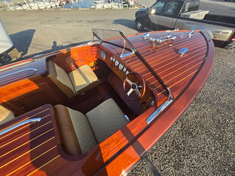 Slide: The Image of 2018 Cherubini Classic 24 boat with polished wood finish and beige seating. - 4