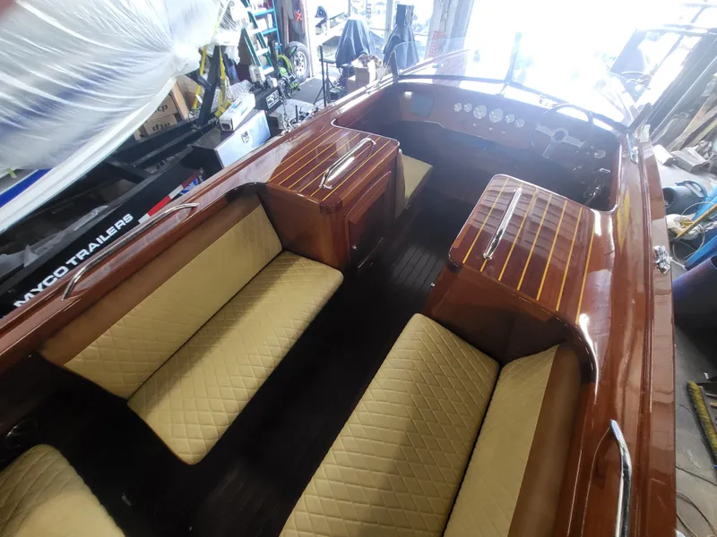 Slide: The Image of 2018 Cherubini Classic 24 boat interior with beige quilted seating and wooden finish. - 43