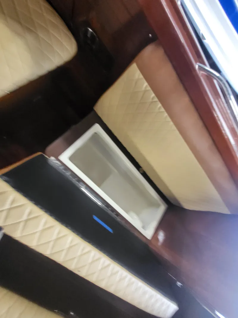 Slide: The Image of 2018 Cherubini Classic 24 boat interior with wooden finish and beige cushioned seating. - 45