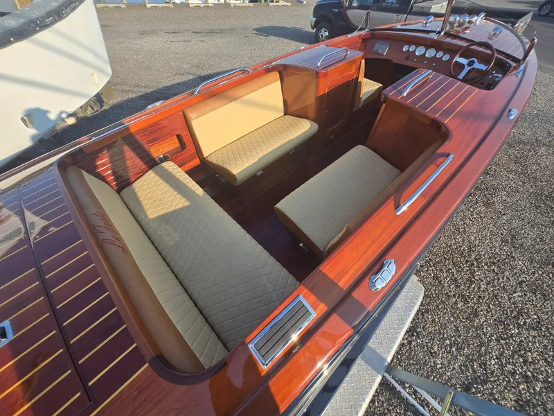 Slide: The Image of 2018 Cherubini Classic 24 boat interior with polished wood and beige seating. - 5