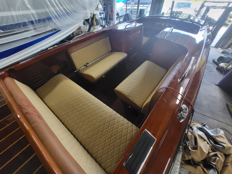Slide: The Image of 2018 Cherubini Classic 24 boat interior with beige quilted seats in a workshop setting. - 52