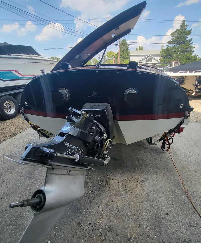 Slide: The Image of Cherubini Classic 24 boat, 2018 model, rear view with outboard motor, parked outdoors. - 54