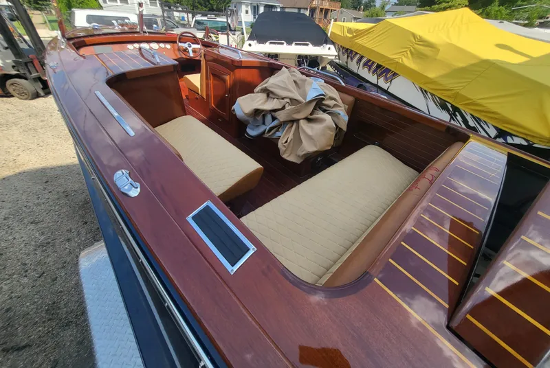 Slide: The Image of 2018 Cherubini Classic 24 boat with wooden deck and beige seating. - 56