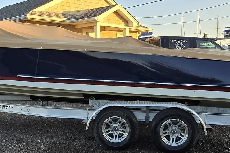 Slide: The Image of 2018 Cherubini Classic 24 boat on trailer, covered, near a house. - 59