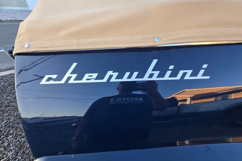 Slide: The Image of Cherubini Classic 24 boat, 2018 model, with tan cover and reflective black surface. - 62