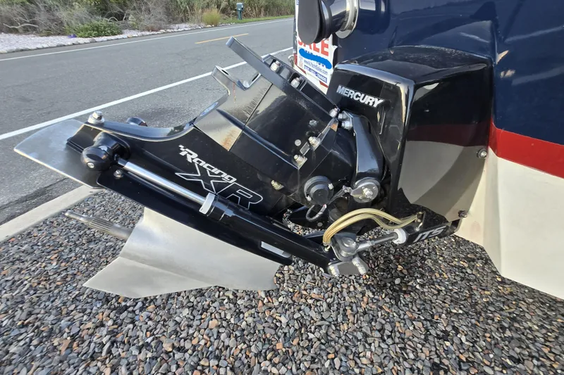Slide: The Image of Mercury Racing XR outboard motor on 2018 Cherubini Classic 24 boat, parked on gravel. - 63