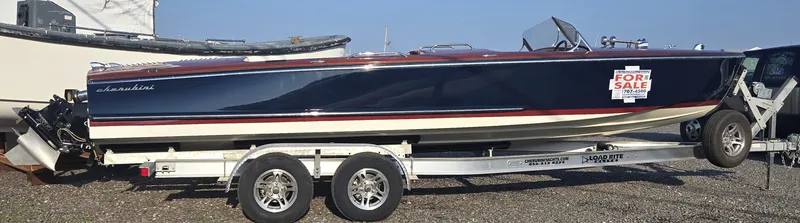 Slide: The Image of 2018 Cherubini Classic 24 boat on trailer, blue hull, "For Sale" sign displayed. - 7