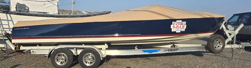 Slide: The Image of 2018 Cherubini Classic 24 boat on trailer, covered, with "For Sale" sign. - 9