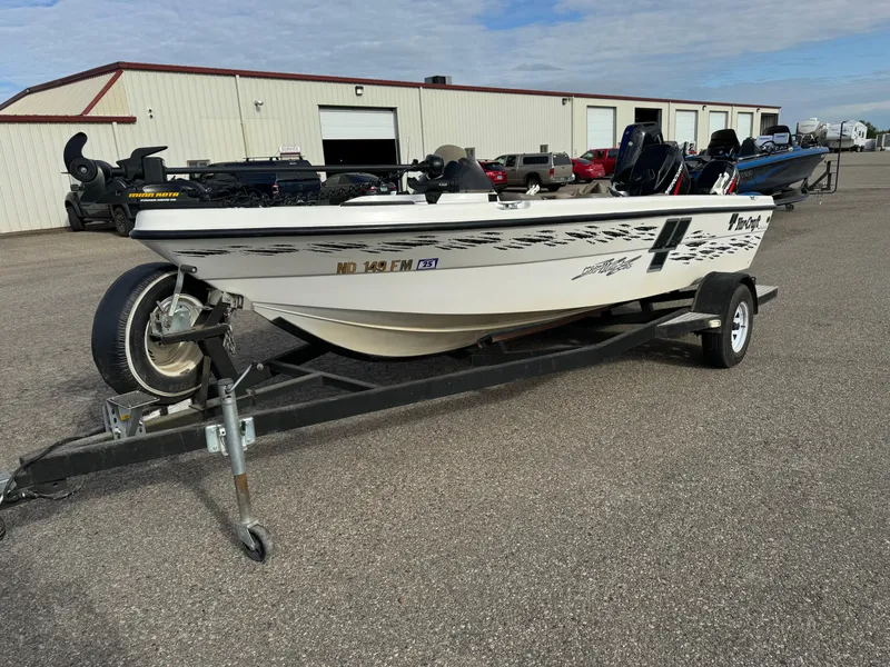 Slide: The Image of 2000 Yar-Craft 1785 Mille Lacs boat on trailer, parked outside a warehouse. - 1