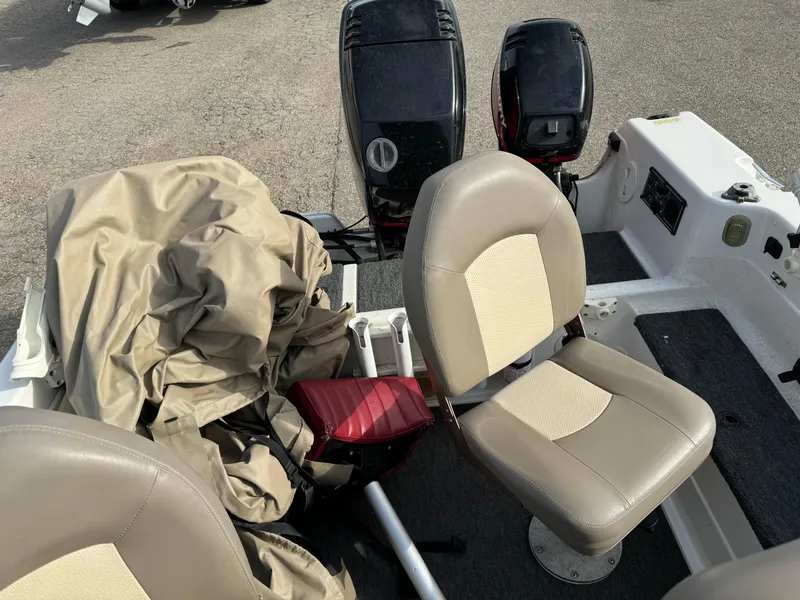 Slide: The Image of 2000 Yar-Craft 1785 Mille Lacs boat interior with beige seats and covered equipment. - 12