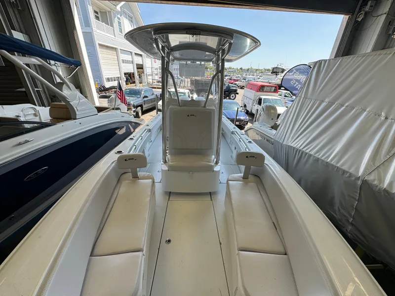 Slide: The Image of 2024 Contender 25 Tournament boat with sleek design and spacious seating in a showroom. - 10