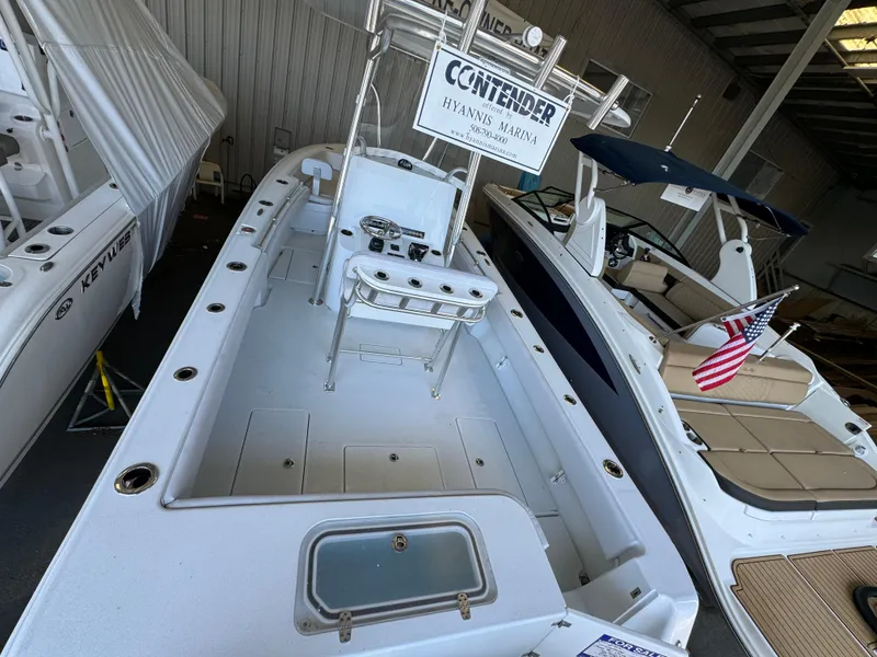 Slide: The Image of 2024 Contender 25 Tournament boat in marina, showcasing spacious deck and fishing setup. - 5