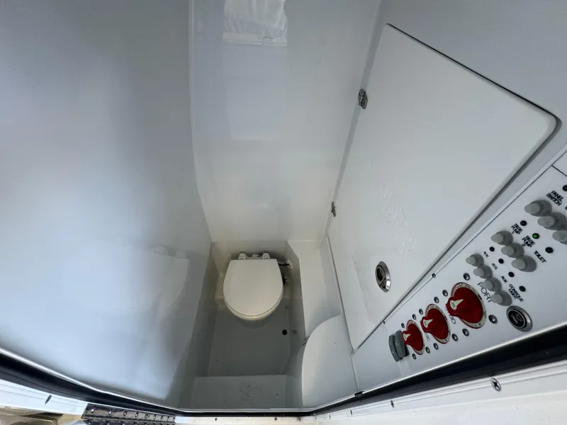 Slide: The Image of 2024 Contender 25 Tournament boat interior with toilet and control panel. - 8