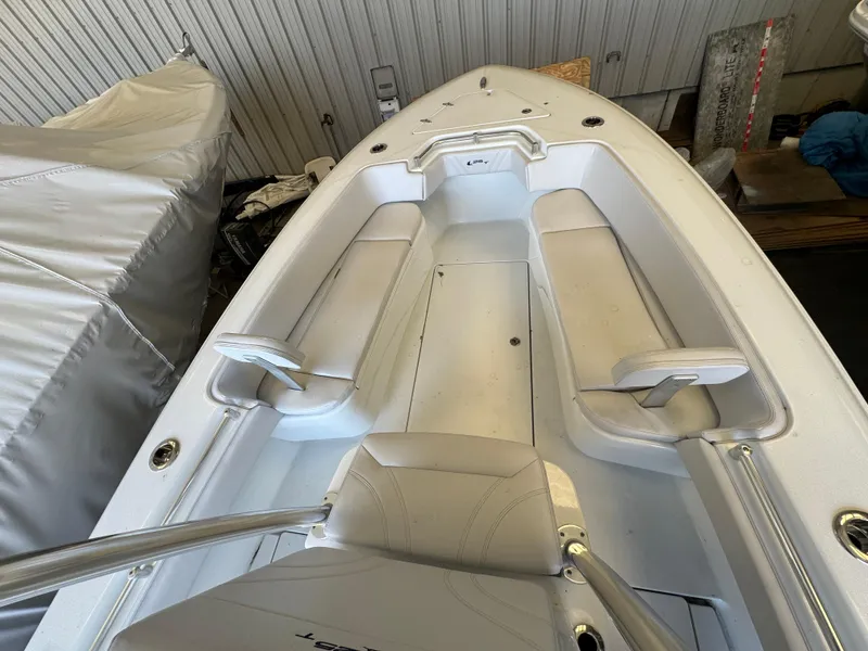 Slide: The Image of 2024 Contender 25 Tournament boat interior with white seating and storage compartments. - 9
