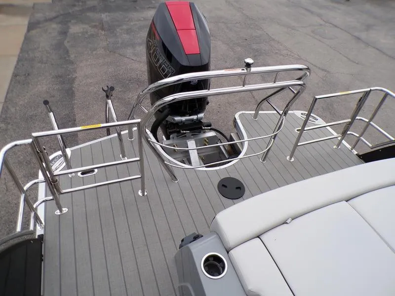 Slide: The Image of 2025 Godfrey Sanpan 2700 DFLW boat deck with motor and railing. - 10