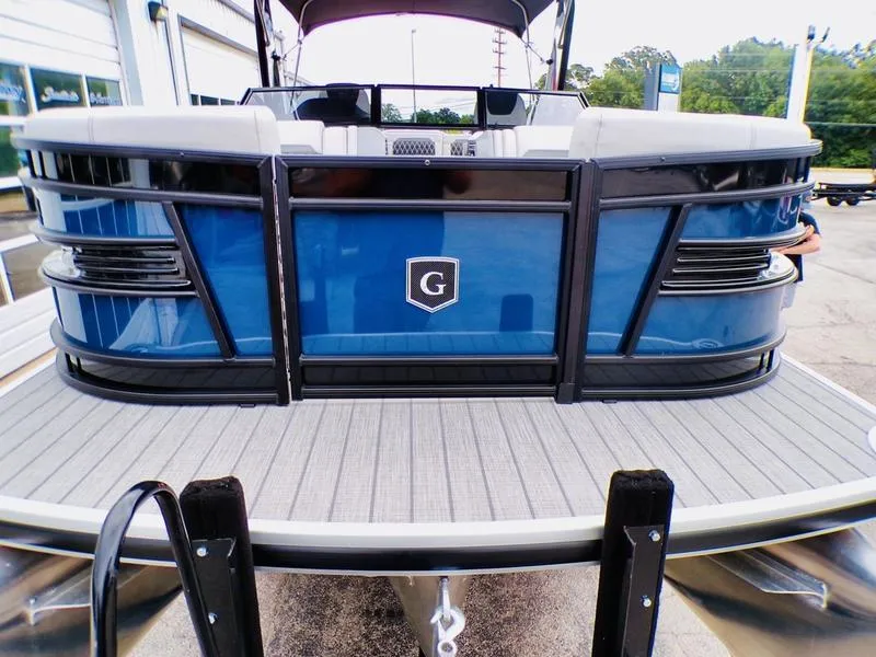 Slide: The Image of 2025 Godfrey Sanpan 2700 DFLW iMPACT PLUS pontoon boat, blue exterior, docked. - 4