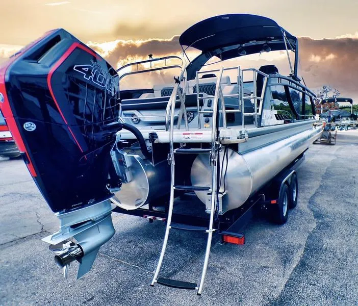 Slide: The Image of 2025 Godfrey Sanpan 2700 DFLW pontoon boat with powerful outboard motor at sunset. - 5