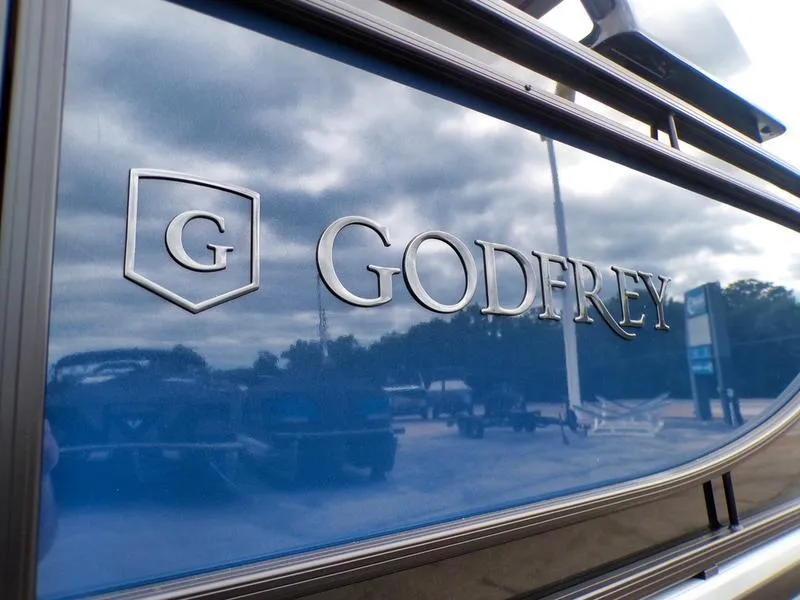 Slide: The Image of 2025 Godfrey Sanpan 2700 DFLW iMPACT PLUS logo on blue boat exterior. - 6