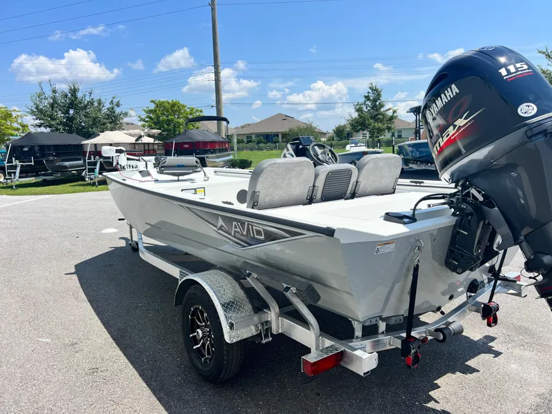 Slide: The Image of Avid 18SC Rouge 2025 boat with Yamaha motor on trailer, parked outdoors. - 13