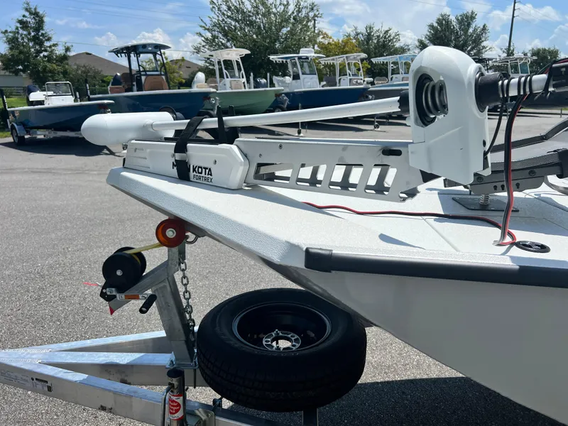 Slide: The Image of 2025 Avid 18SC Rouge boat on trailer with Minn Kota motor. - 2