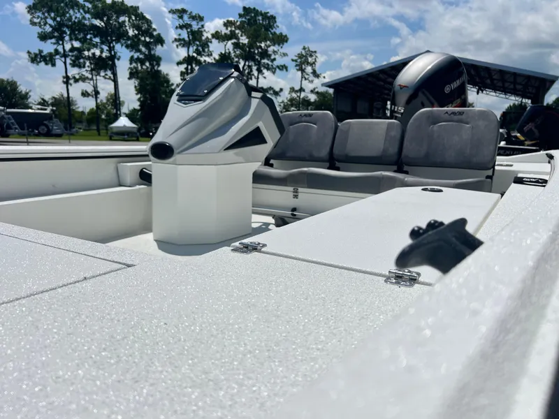 Slide: The Image of Avid 18SC Rouge 2025 boat interior with seating and console, outdoors under blue sky. - 4