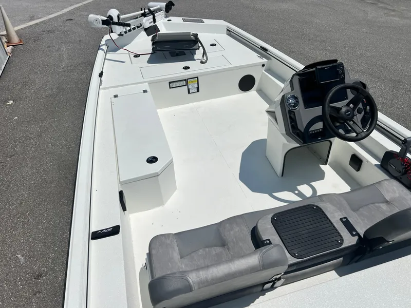 Slide: The Image of 2025 Avid 18SC Rouge boat interior with steering console and seating. - 7