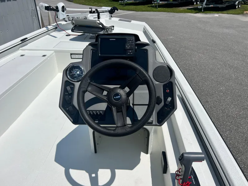 Slide: The Image of 2025 Avid 18SC Rouge boat dashboard with steering wheel and navigation controls. - 9