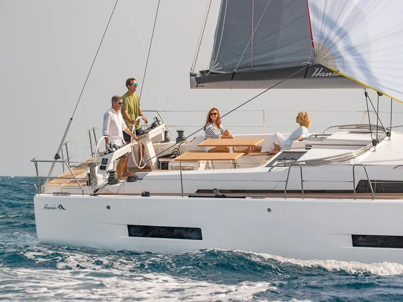 Slide: The Image of 2025 Hanse 510 yacht sailing with passengers on deck in open water. - 30