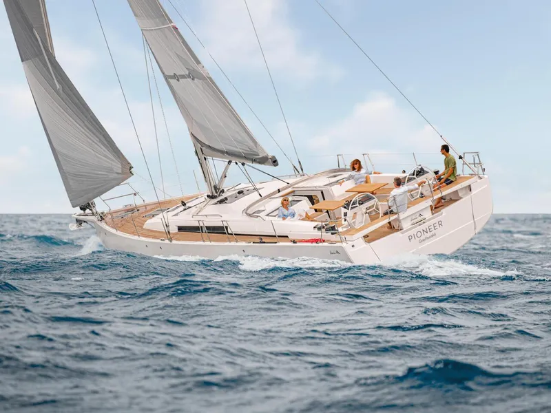Slide: The Image of 2025 Hanse 510 sailboat navigating ocean waves under clear skies. - 32