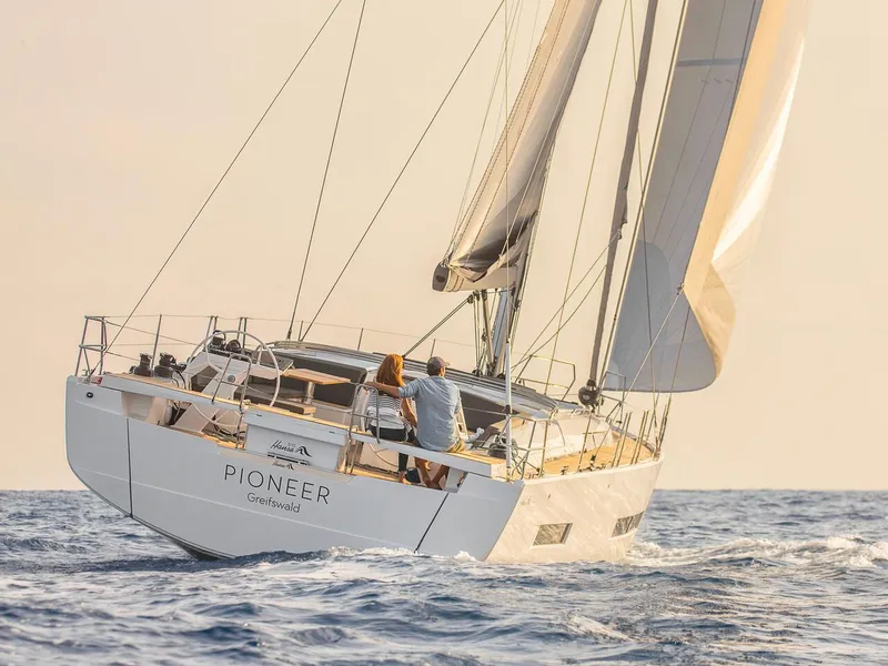 Slide: The Image of 2025 Hanse 510 sailboat on open sea, sailing with full sails in sunlight. - 34