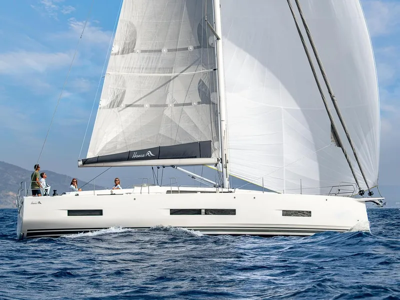 Slide: The Image of 2025 Hanse 510 sailboat navigating open waters with full sails. - 37
